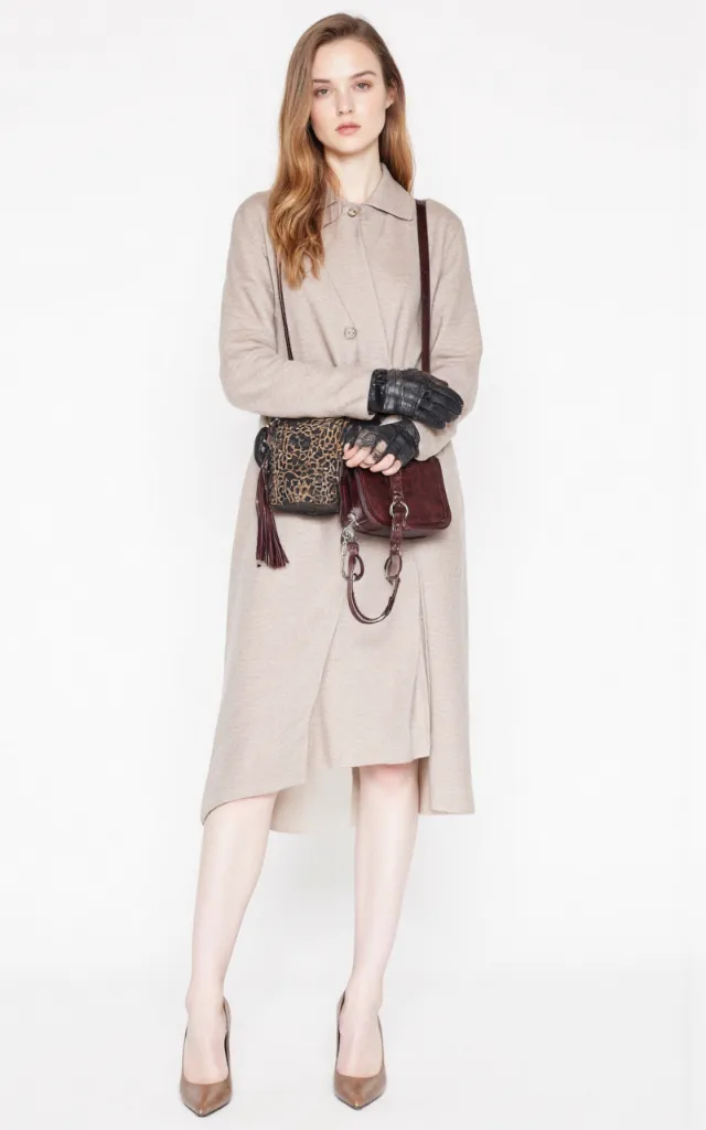 A French female model wearing Chic   style clothing, against a white background, in a front   facing shot focusing on shoes